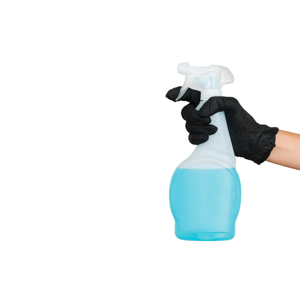 A hand using a black glove grabbing a cleaning bottle with blue liquid